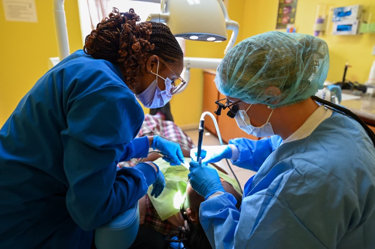 Dental clinicians treating a patient in a clinic, illustrating NHS dental care and the 2026 contract reforms